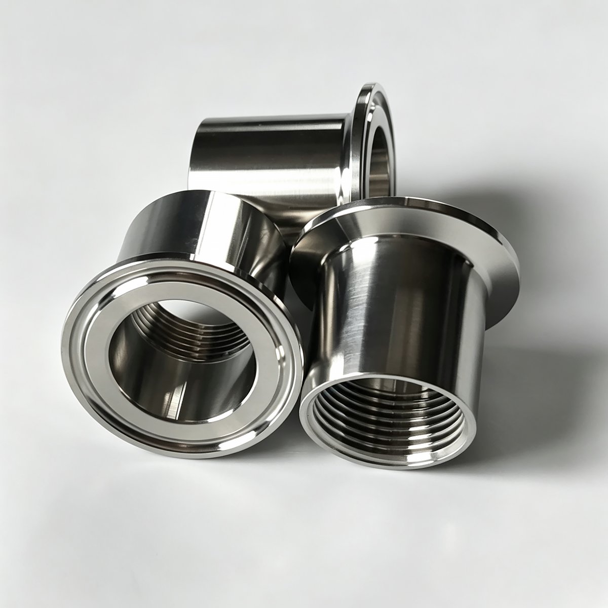 Multiple 304 stainless steel sanitary clamp female thread adapters stacked together