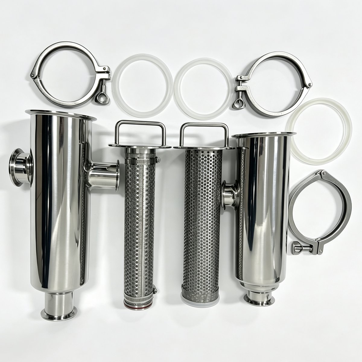 Disassembled sanitary Tri-Clamp straight-through filter showing housing, perforated screens, clamps and gaskets