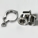 Sanitary tri-clamp next to clamp-to-female threaded adapters showing the difference between clamp and threaded connections